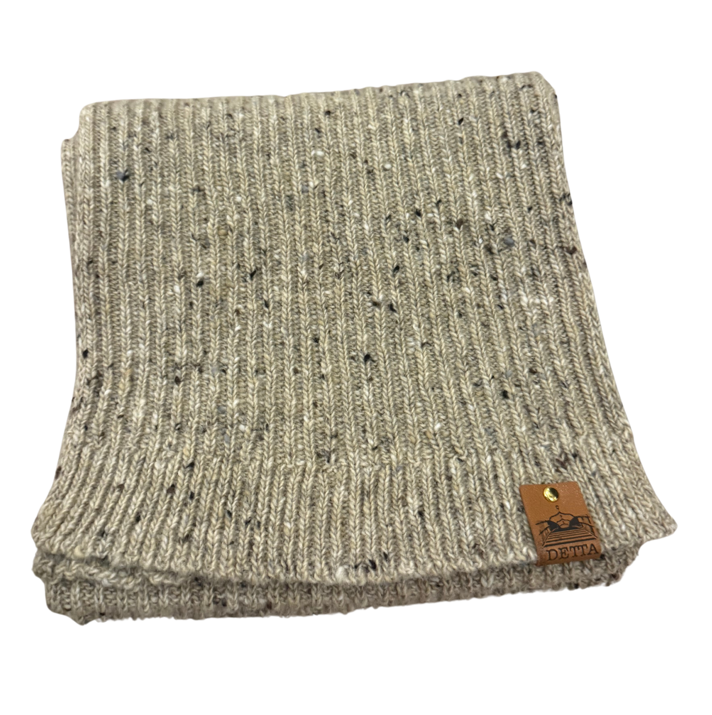Folded oatmeal knit scarf with a brand label on a white background